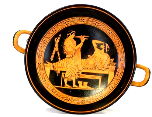 Red figured kylix featuring Dionysus resting under the sound of a flute.